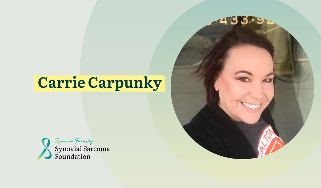 A woman with short brown hair smiles at the camera. Text reads "Carrie Carpunky." The Synovial Sarcoma Foundation logo is in the lower left corner. The background features green and yellow circular designs.