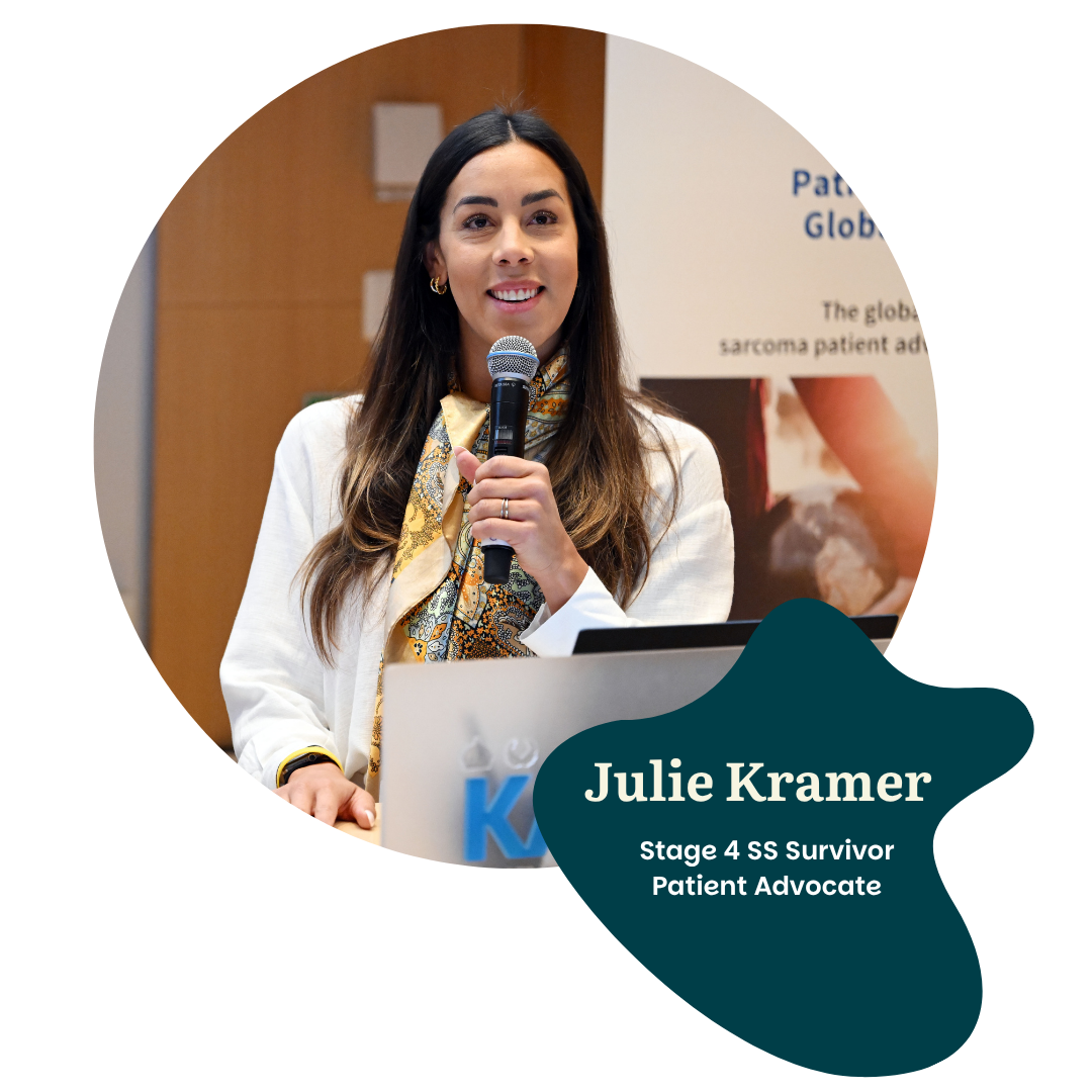 A woman with long dark hair holds a microphone and speaks at a podium. She is smiling and wearing a white blazer and patterned scarf. Text reads: "Julie Kramer, Stage 4 SS Survivor, Patient Advocate.