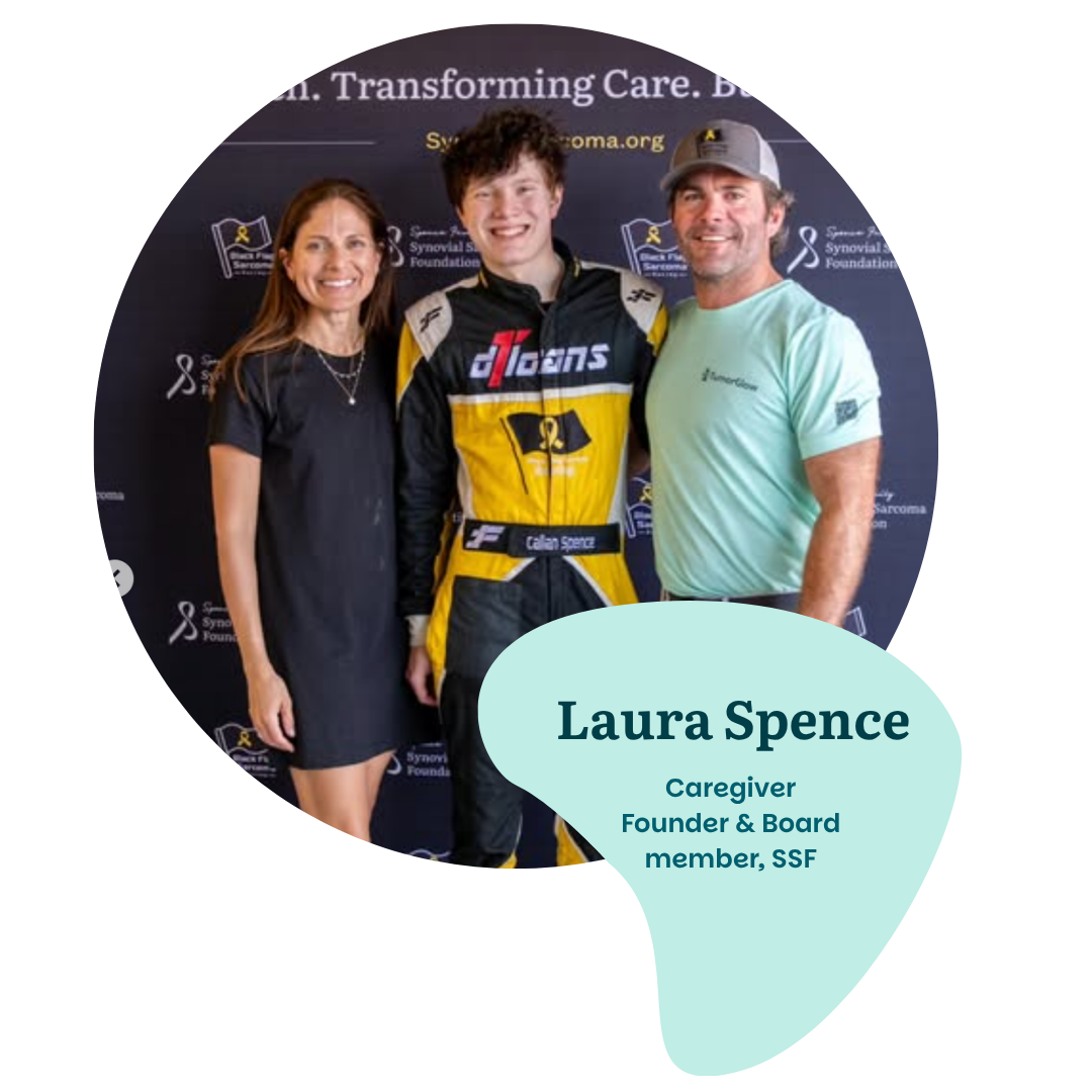 Three people stand smiling in front of a Swan Song Sarcoma Foundation banner. The woman on the left is labeled as Laura Spence, caregiver and board member of SSF. The person in the center wears a racing suit.